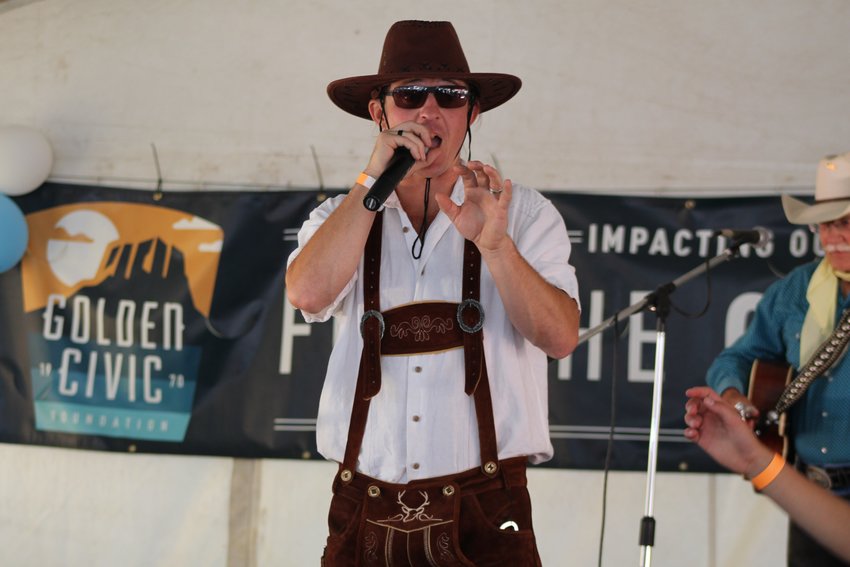 Emcee Mickey Wilson makes an announcement during Wild West Oktoberfest Sept. 24 in downtown Golden.